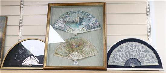 A framed pair of painted fans and two others, (three hand painted)